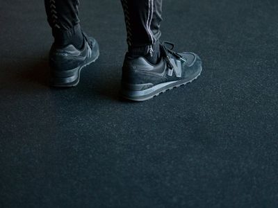 Close-up of athletic shoes on a textured gym floor.